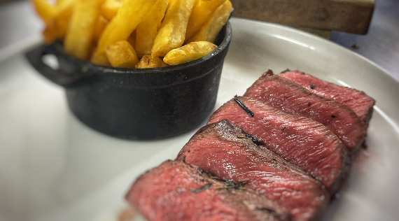 T-bone steak with a pint of London Pride